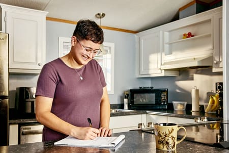 Lady writing on a notepad